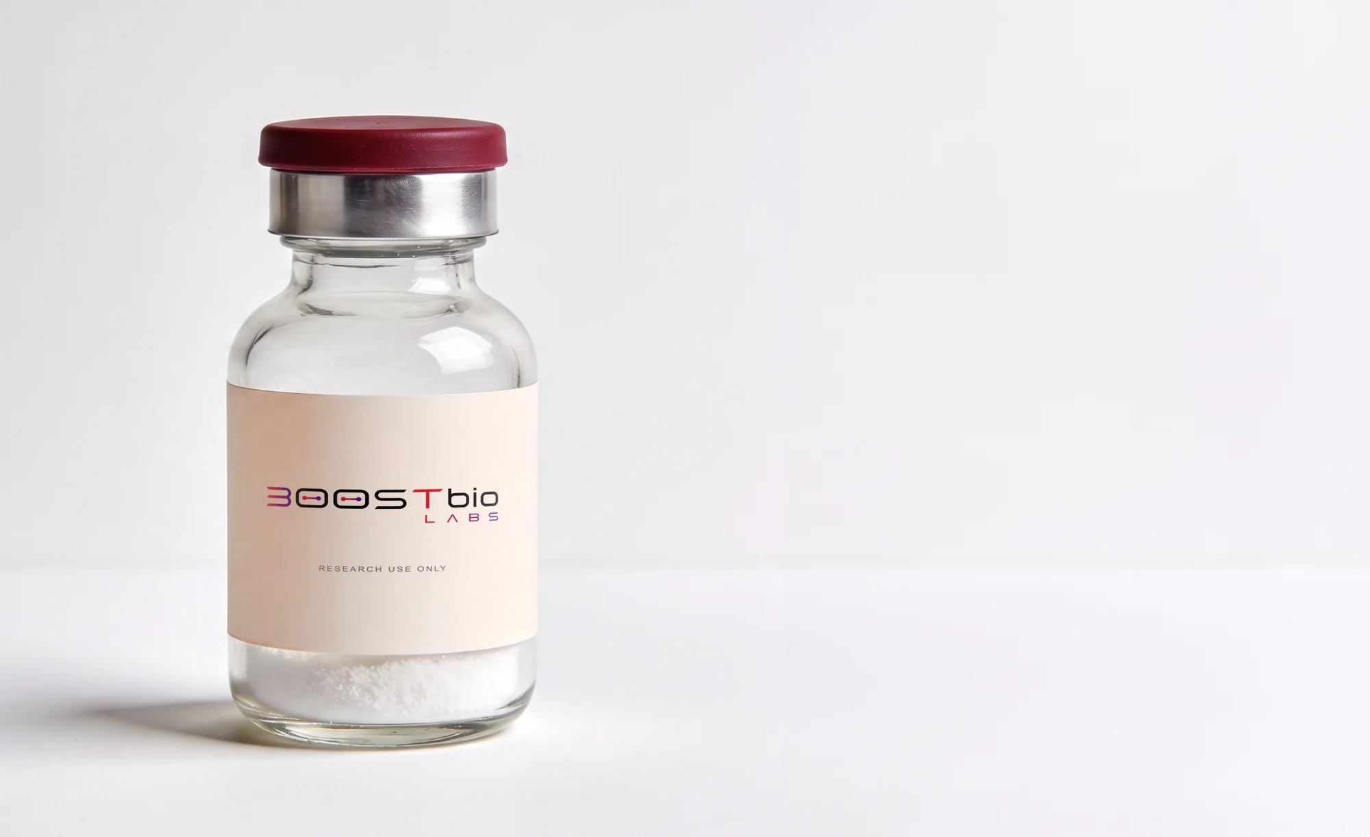 A sealed BOOSTBio Labs laboratory vial: clear borosilicate glass, aluminium crimp seal, lyophilized powder.
