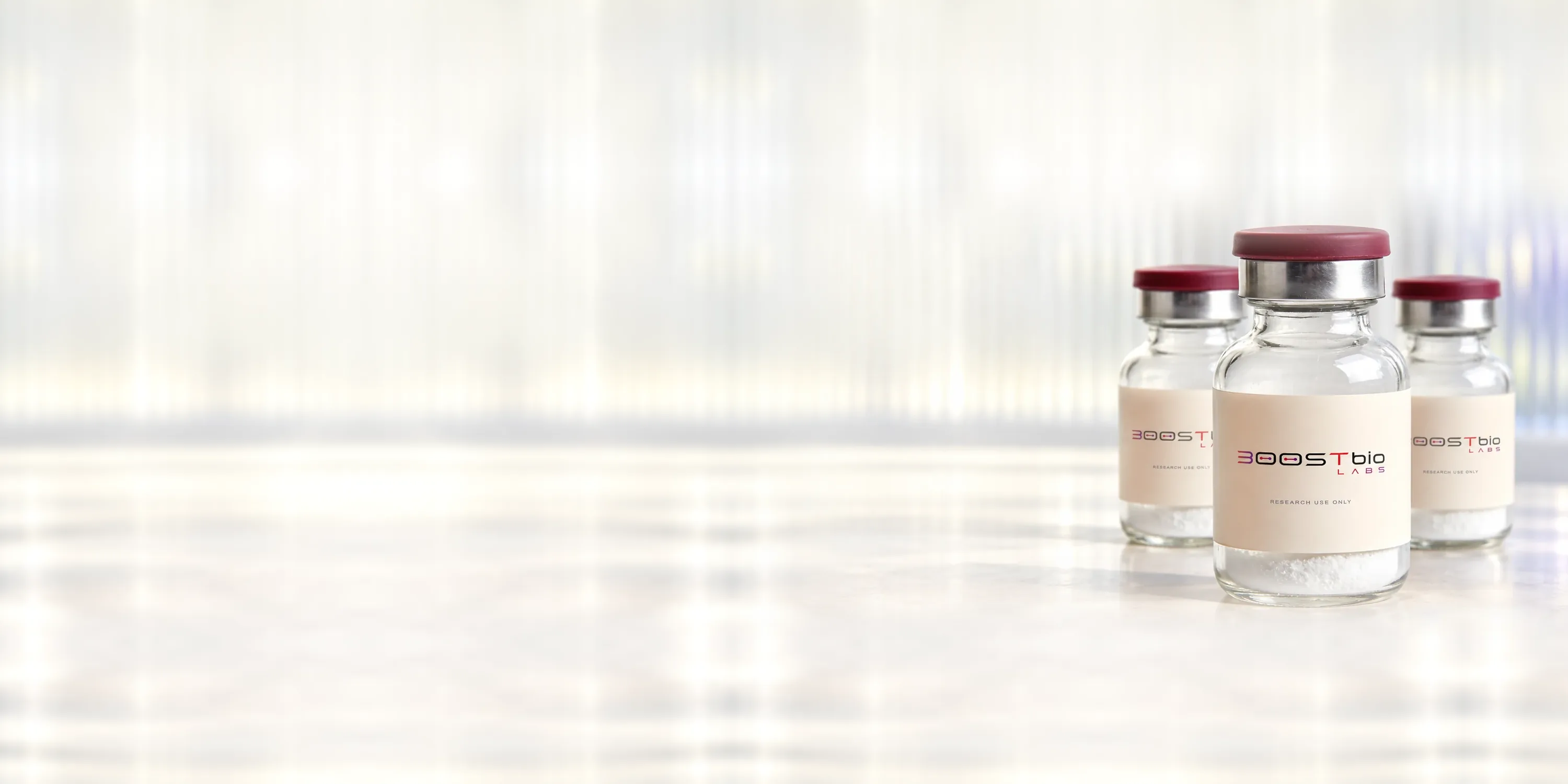 Sealed BOOSTBio Labs reference vials on a light laboratory bench.